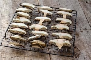 Sliced mushrooms on a cooling rack after drying in the oven