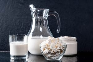 dairy products on a table, cheese, cream, and milk