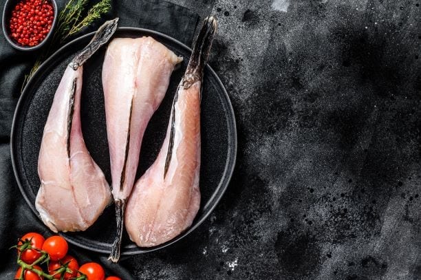 raw monkfish fillet, deboned monkfish on a plate with tail