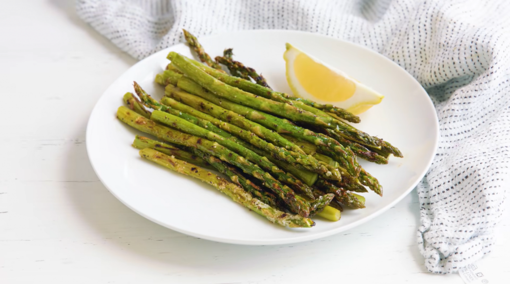 asparagus with lemon on a white plate