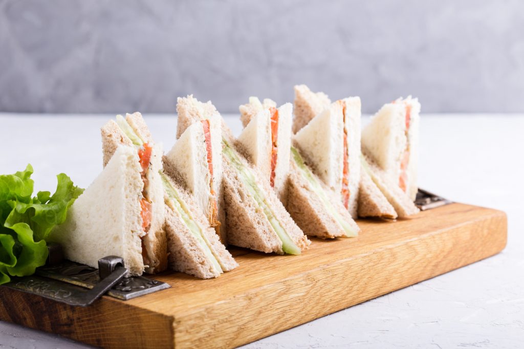 English tea sandwiches platter on wooden board