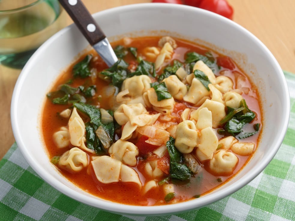 a bowl of tortellini vegetable soup