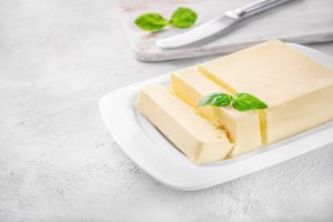 fresh butter in a white ceramic butter dish