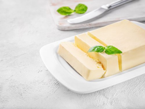 fresh butter in a white ceramic butter dish