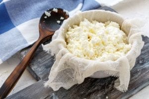 cheese cloth with cottage cheese, freshly made cheese on a cheesecloth