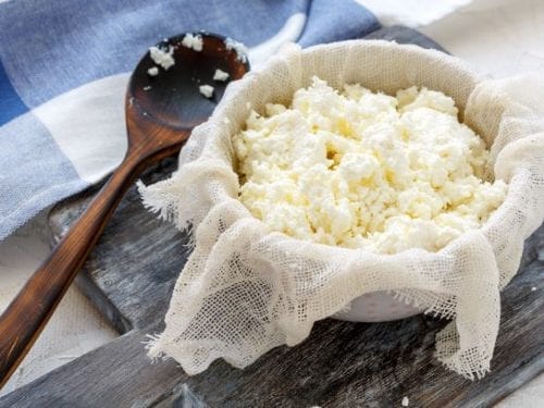 cheese cloth with cottage cheese, freshly made cheese on a cheesecloth