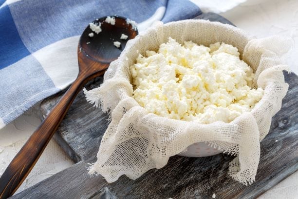 cheese cloth with cottage cheese, freshly made cheese on a cheesecloth