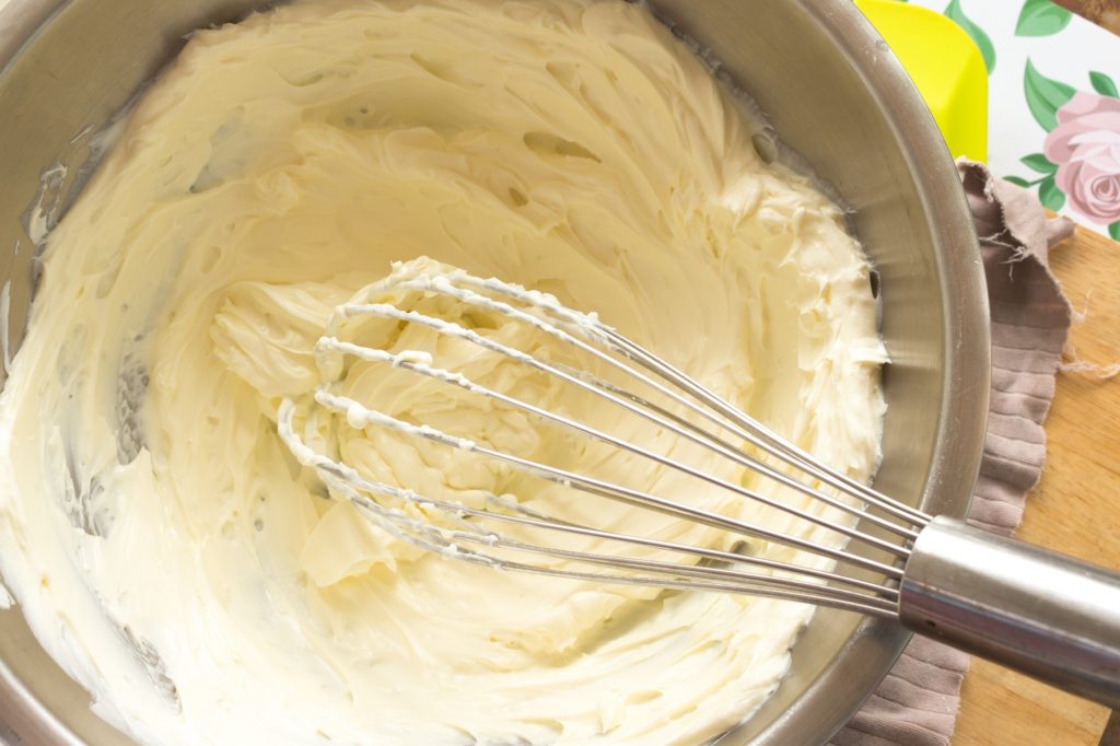 Bowl of cream cheese with whisk