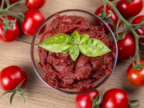 a bowl of tomato paste and fresh tomatoes