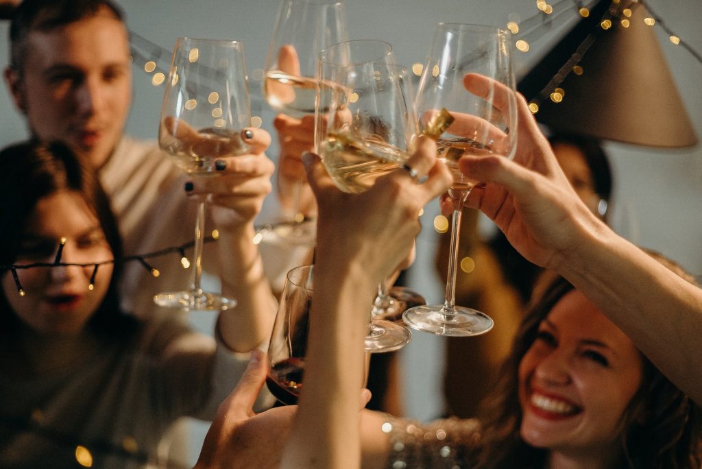 People celebrating with glasses of white wine
