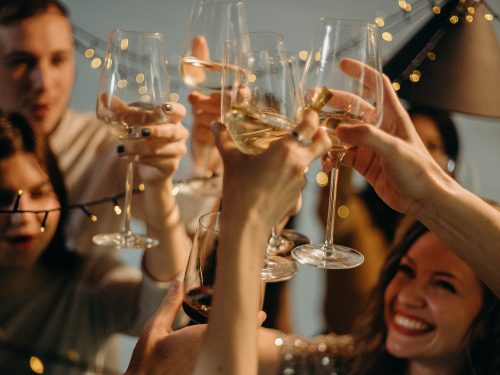 People celebrating with glasses of white wine