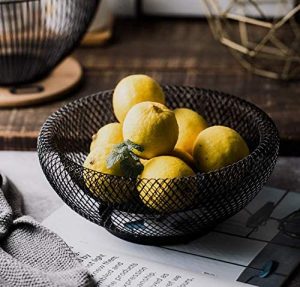 Lemons in black wire mesh fruit bowl