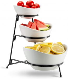 Various fruits in three tiered ceramic fruit bowls with stand
