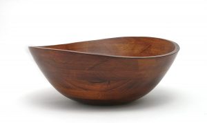 Large wooden fruit bowl with a wavy rim design