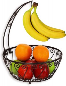 Various fruits in classic fruit bowl with banana hanger