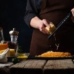 a person grating cheese
