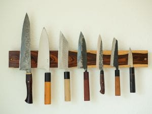Kitchen utensils on a magnetic knife strip