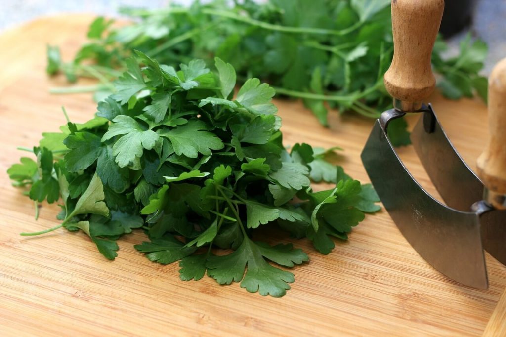 parsley on a wooden chopping board