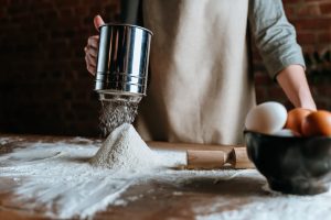 sifting flour, person sifting flour, baking