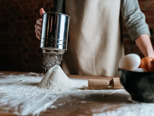 sifting flour, person sifting flour, baking