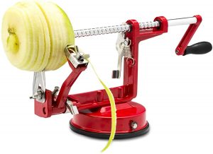 Red apple and potato peeler by Spiralizer peeling an apple
