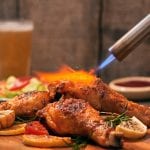 crispy fried chicken and a flaming kitchen torch