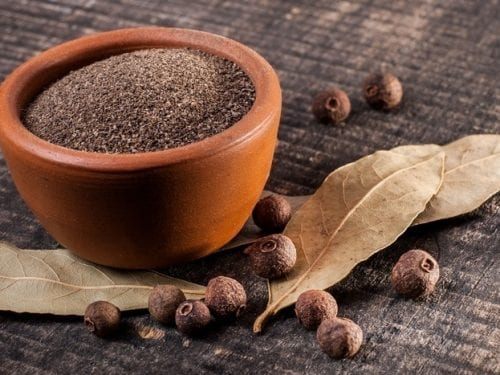 Allspice Substitutes, Ground and whole allspice berries on the table