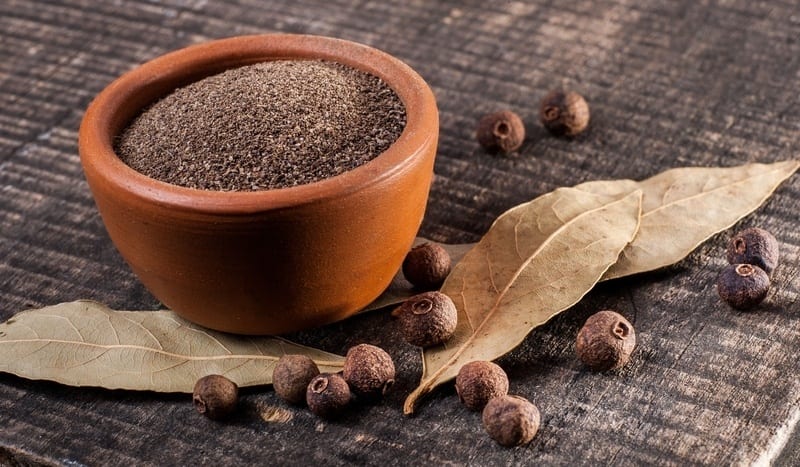 Allspice Substitutes, Ground and whole allspice berries on the table