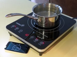 Metal pot on a portable induction cooktop
