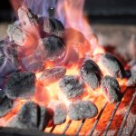 Burning lump charcoal on a grill