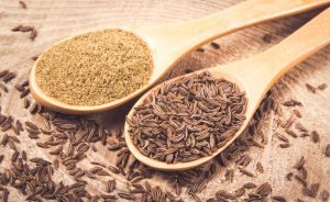 Ground and whole cumin on wooden background, Cumin Substitutes