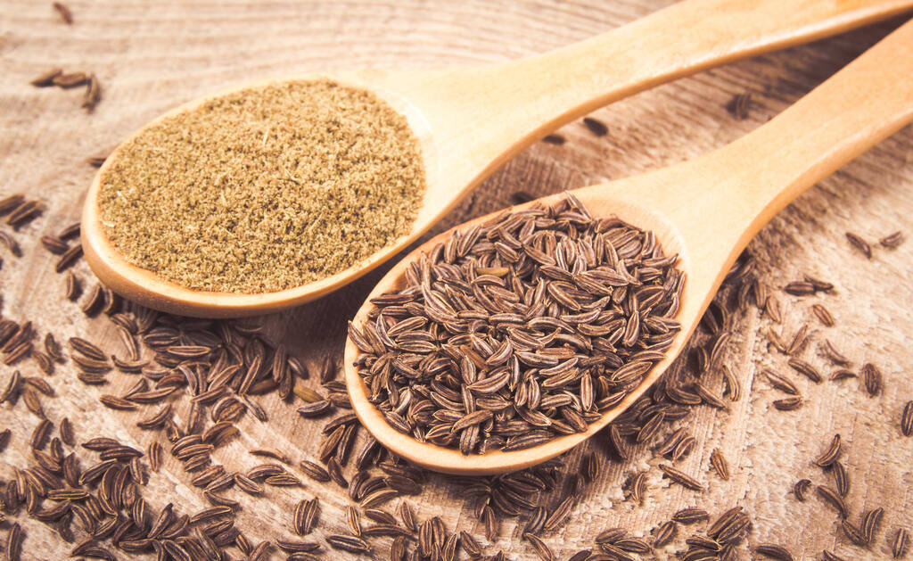 Ground and whole cumin on wooden background, Cumin Substitutes