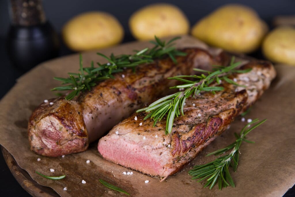 Sous Vide Pork Tenderloin Recipe, firm juicy medium rare pork loin sous vide with fresh herbs