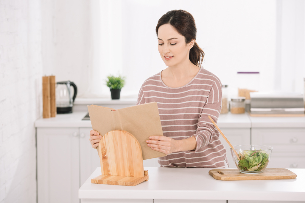 woman reading a recipe book, Best Cookbook Stands