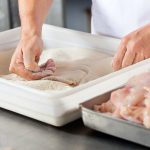 dredging chicken meat in the flour
