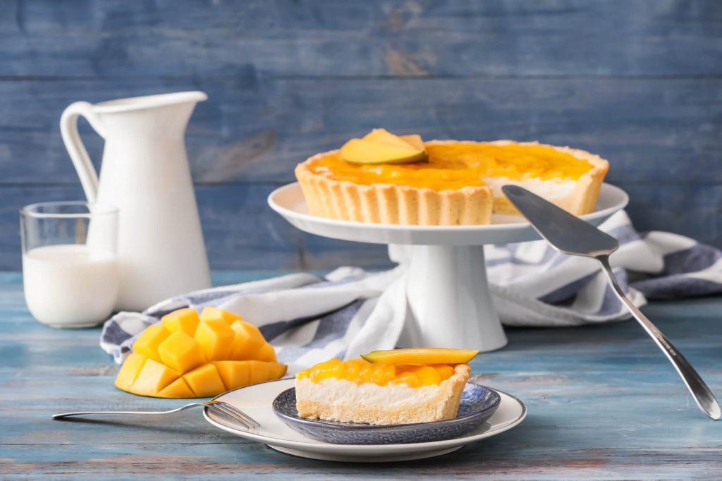 delicious mango pie on a wooden dessert stand