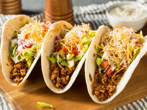 Soft Tacos Recipe, soft tacos made with flour tortillas and filled with ground beef, taco seasoning, cheddar cheese, and refried beans