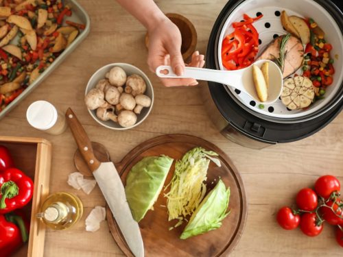 Woman scooping ingredients from an Instant Pot, Instant Pot chicken recipes