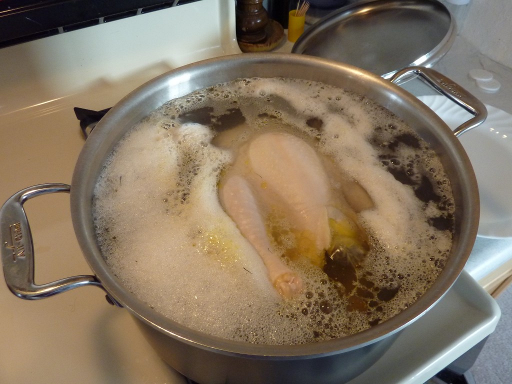 Chicken in a pot of boiling water