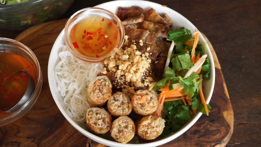 nuoc cham, rice noodles, and grilled pork in a bowl