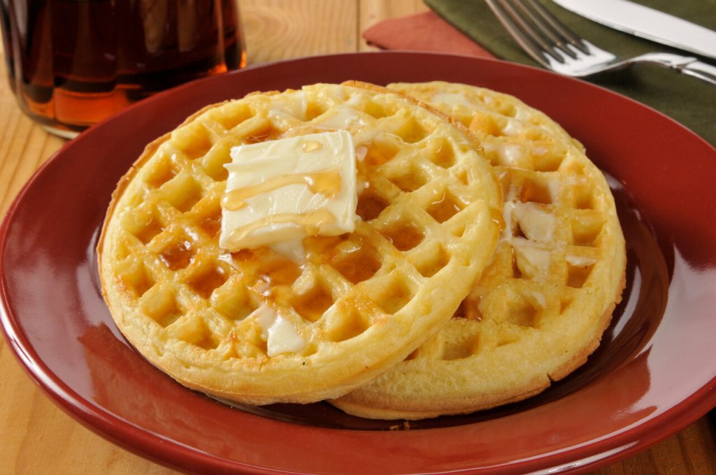 eggo waffles with butter and maple syrup on a plate