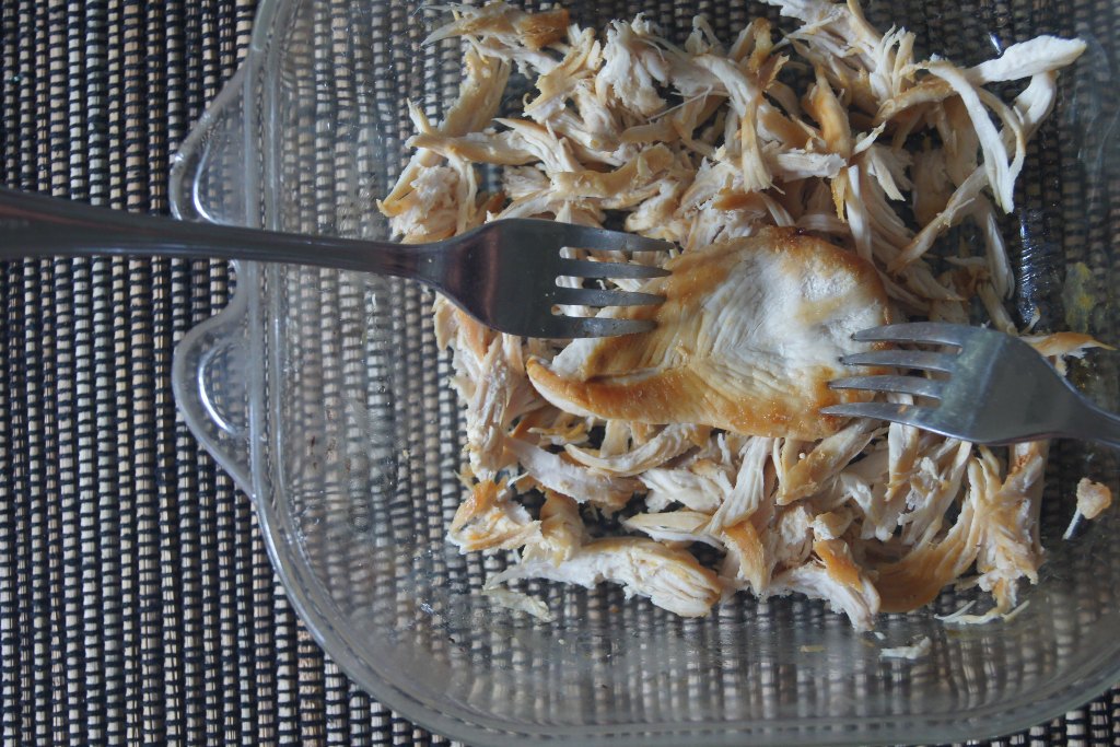 Shredded chicken with two forks