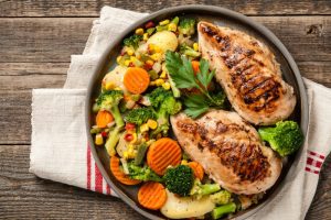Grilled chicken breast fillets with chopped vegetables, healthy chicken recipes