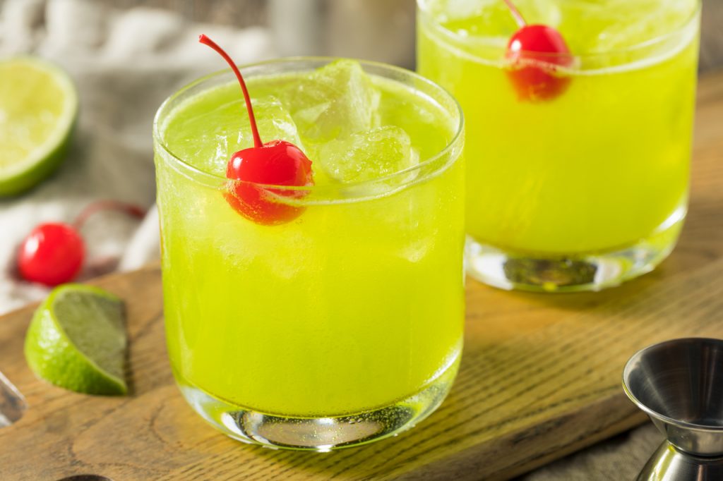 Midori Sour Recipe, Midori sour served in a glass with a cherry on top