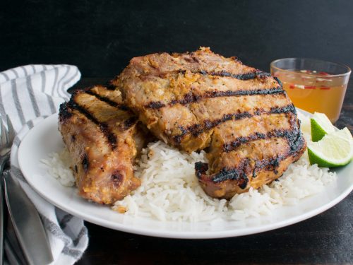 vietnamese pork chops on a bed of rice with lemon and nuoc cham