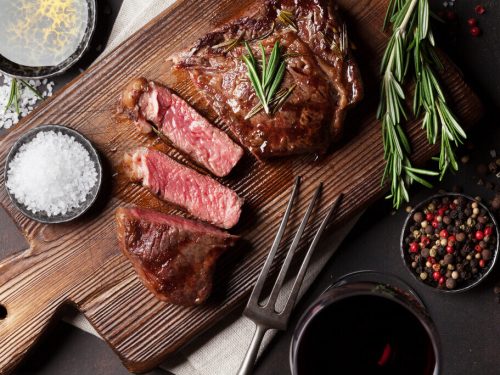 steak cut on chopping board, grilled ribeye, best cut of steak
