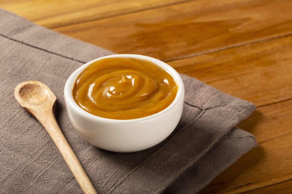 Close-up of jar full of dulce de leche. Dulce de leche, traditio