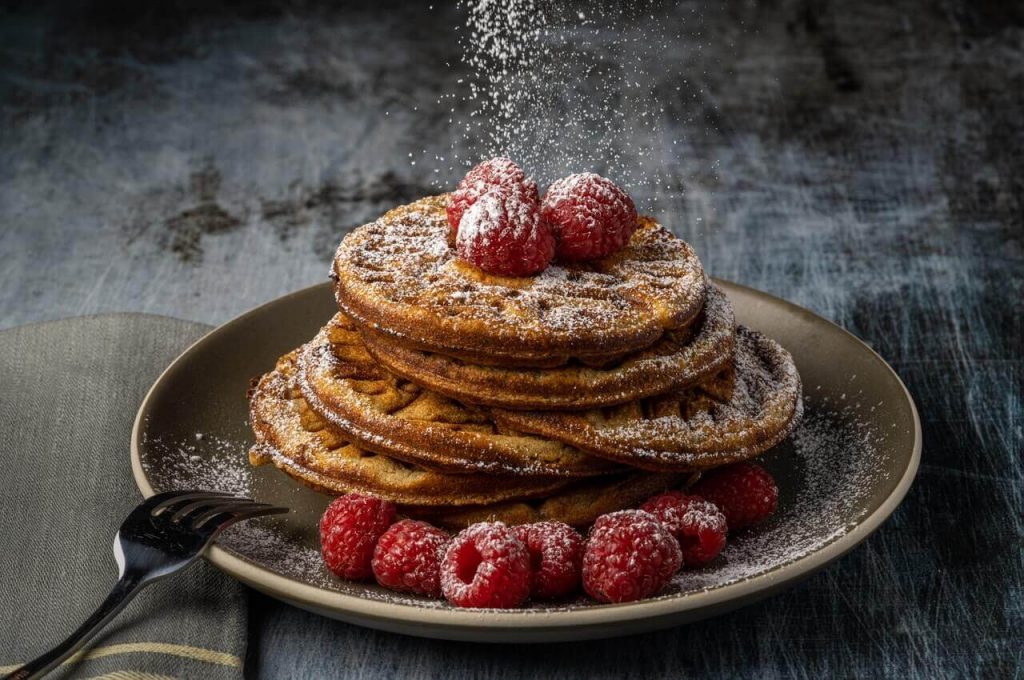 elegant pancake with raspberry dusted with powder, fancy desserts