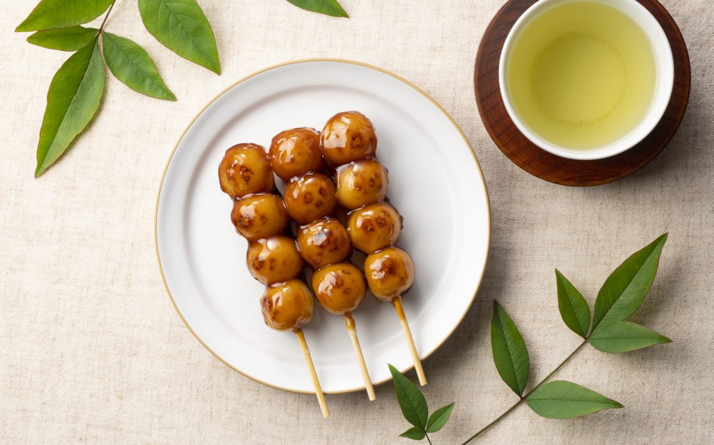 Mitarashi dango and green tea placed on a cloth