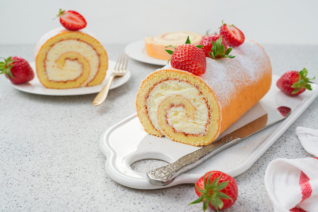 Tasty roll cake stuffed with cream cheese ,decorated with fresh